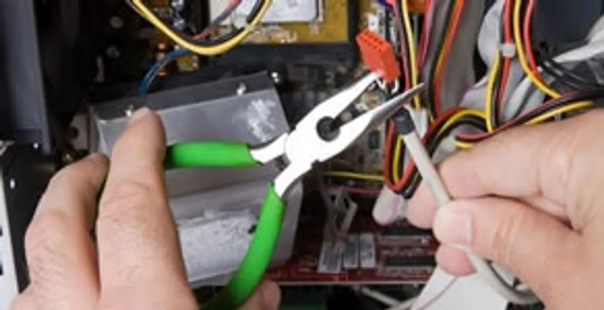 Licensed electrical contractor performing electrical repair with tools in Lutz, FL