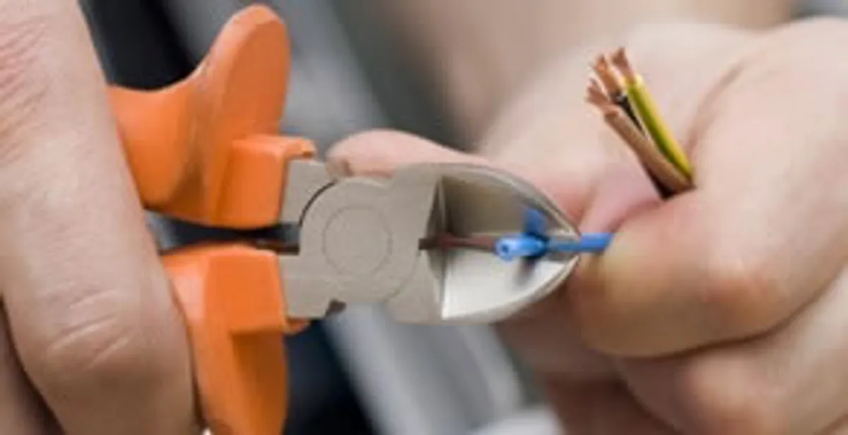professional electrical services showing precise wire cutting by licensed electricians in Tampa, FL